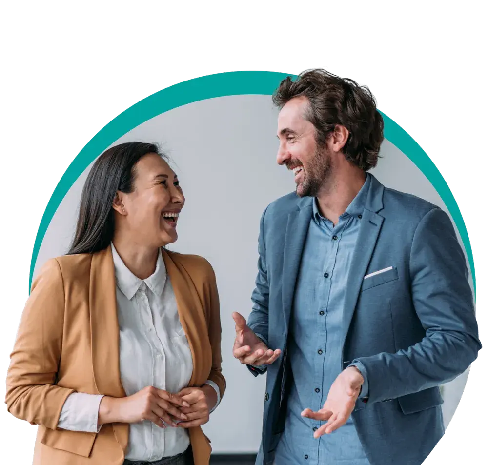 man & woman in business casual smiling & talking together
